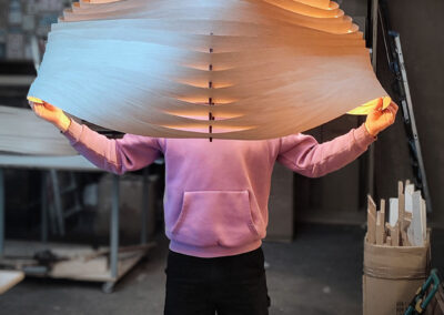 alt= "Suspension design, bois, forme ondulée, éclairage indirect, espace de vie, moderne, design, éclairage doux, indirecte, contemporain, ambiance chaleureuse"